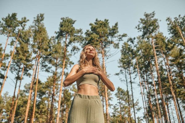 A woman practising yoga in the park and looking involved