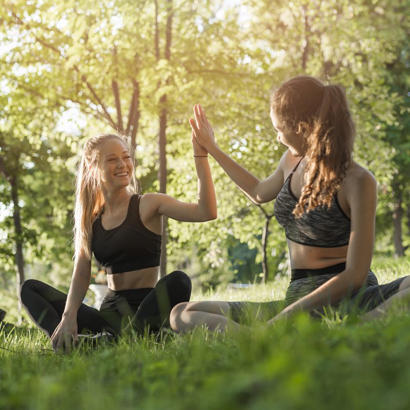 young-women-doing-yoga-park
